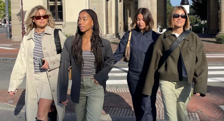 Vier meiden lopen samen over straat.