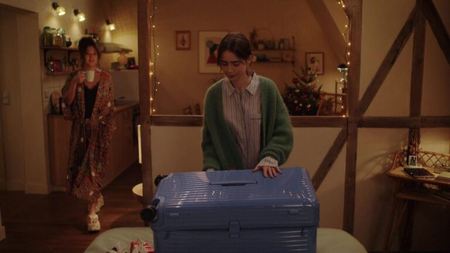 Emily maakt haar koffer open in haar nieuwe kamer.