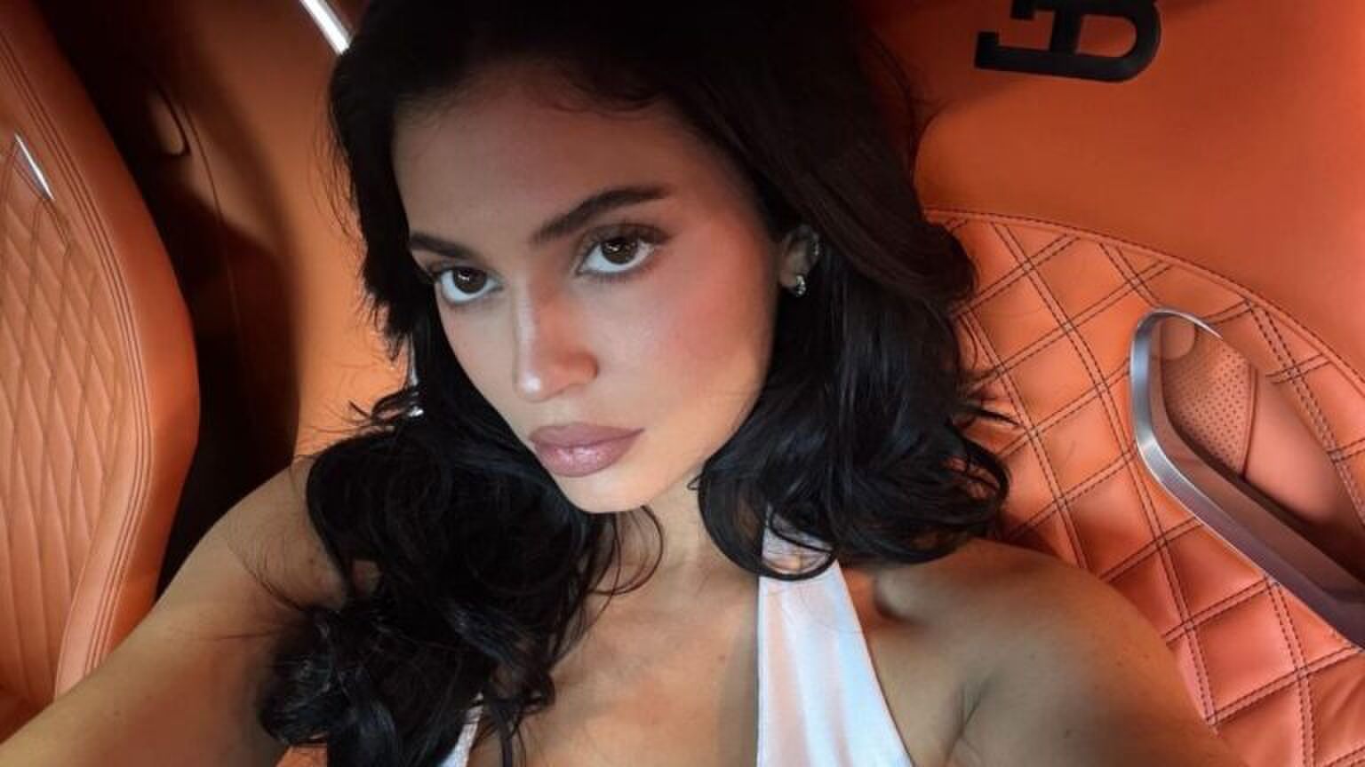 Selfie Kylie Jenner in een oranje auto.