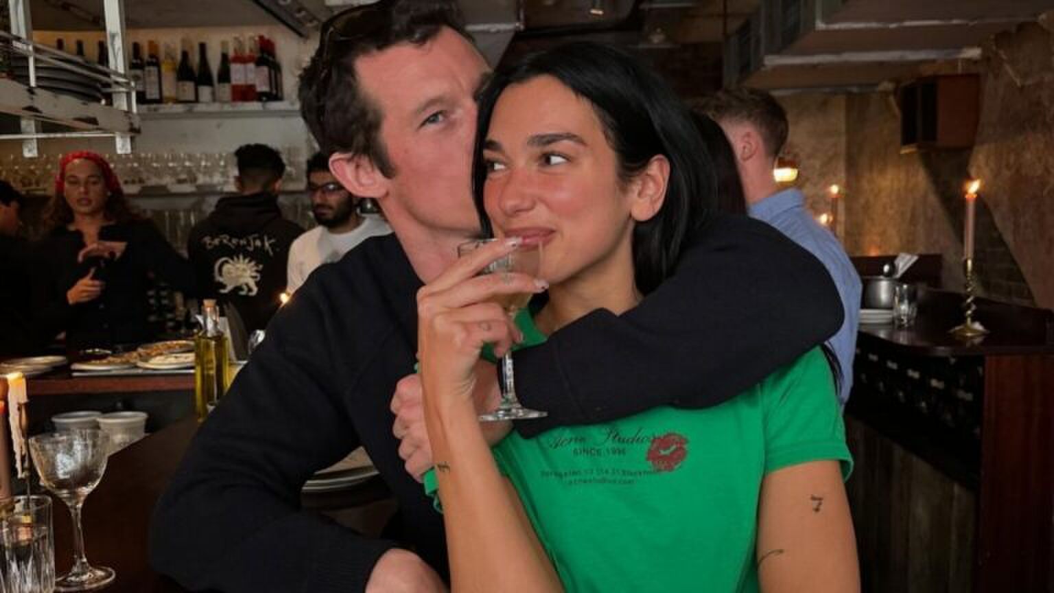 Dua Lipa met een glas wijn in haar hand, en haar man