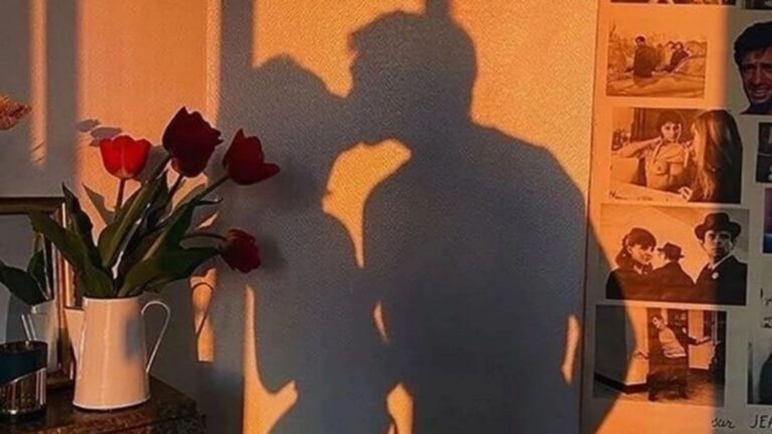 Een schaduw van een meisje en een jongen die kussen.