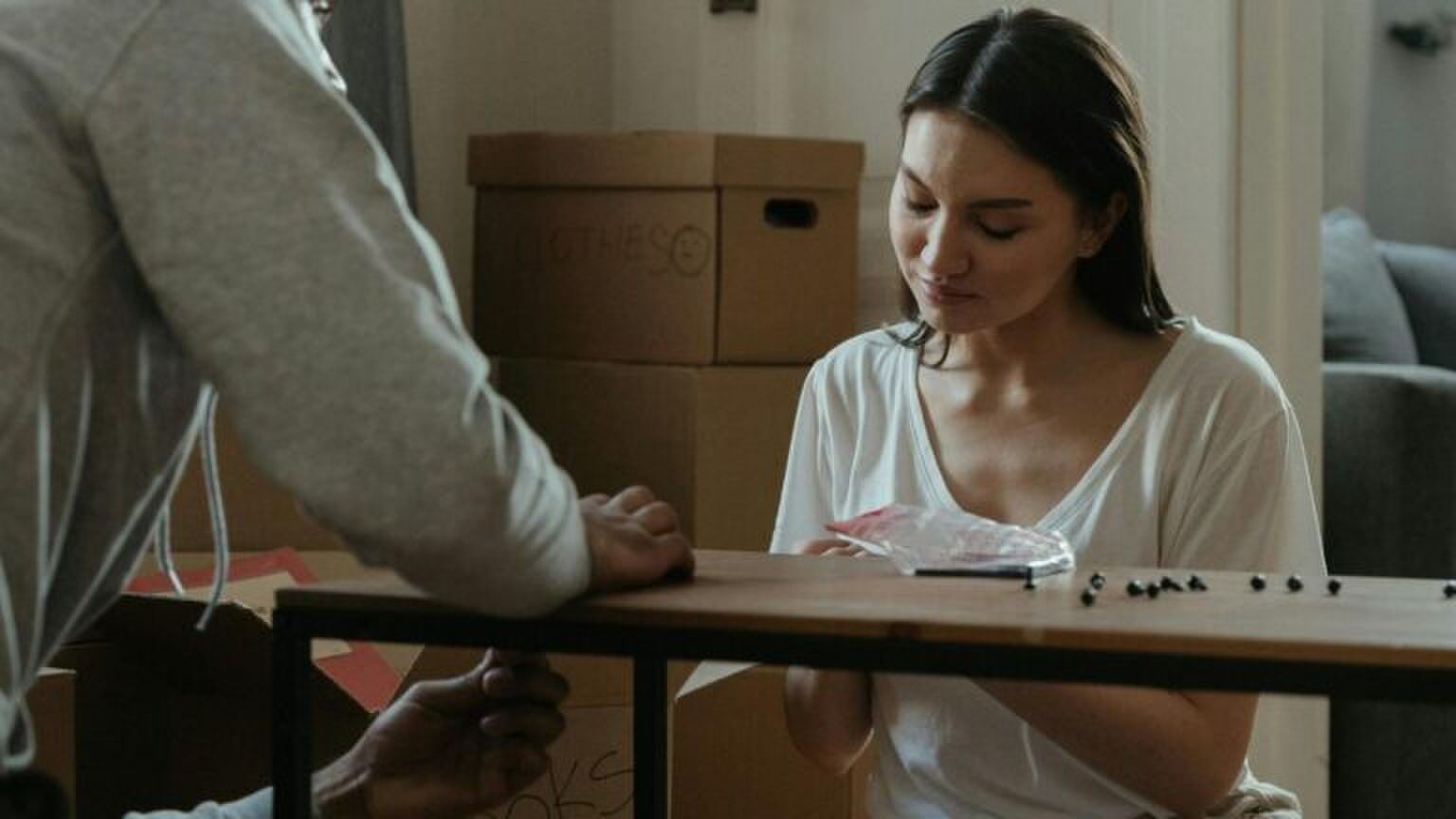 Een vrouw zet een tafel in elkaar.
