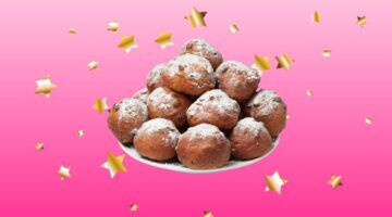 Schaal oliebollen met sterretjes op de achtergrond.