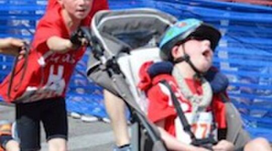 Illustratie voor: Jongen draagt gehandicapte broertje mee tijdens triatlon