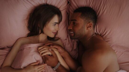 Alfie en Emily uit Emily in Paris in bed.