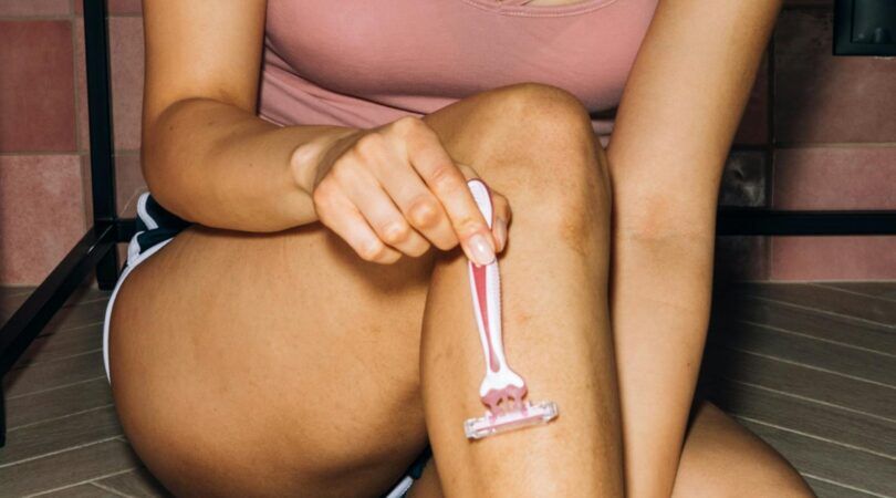 Vrouw scheert haar benen.