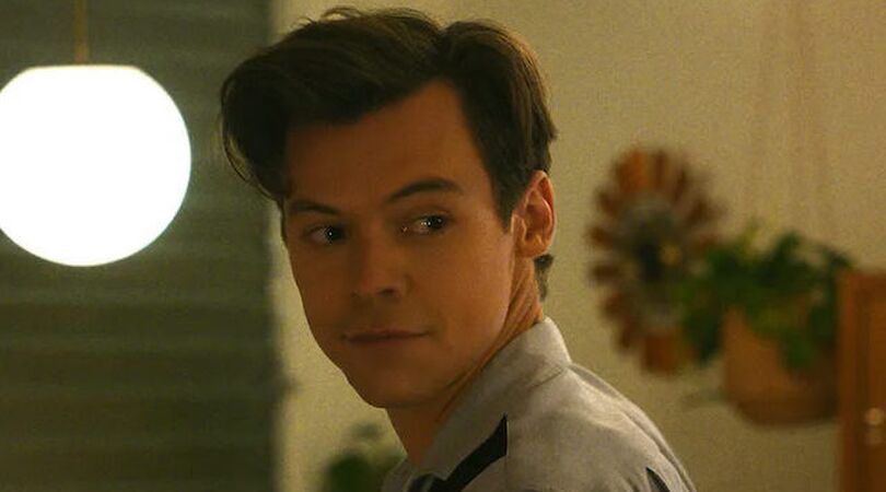Harry Styles kijkt over zijn schouder.