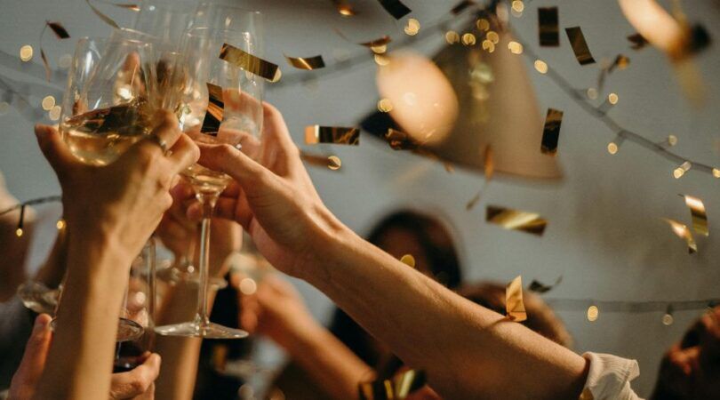 Verschillende mensen heffen het glas om te proosten.
