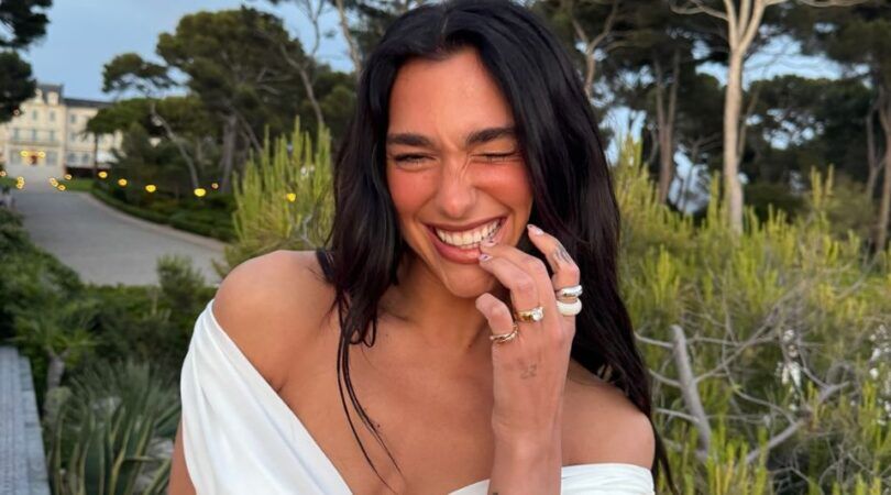 Dua Lipa lacht naar de camera.