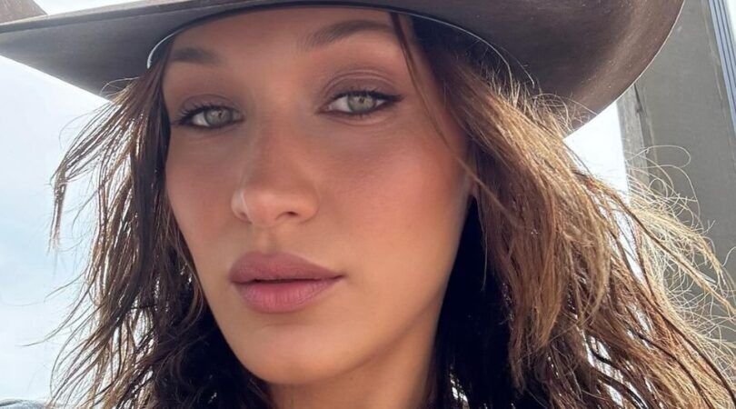 Vrouw met cowboyhoed maakt een selfie.