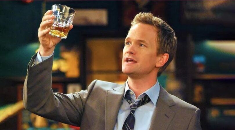 Man houdt een drankje omhoog.