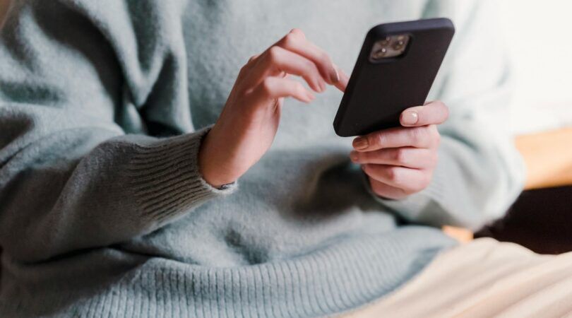 Iemand kijkt op haar telefoon.